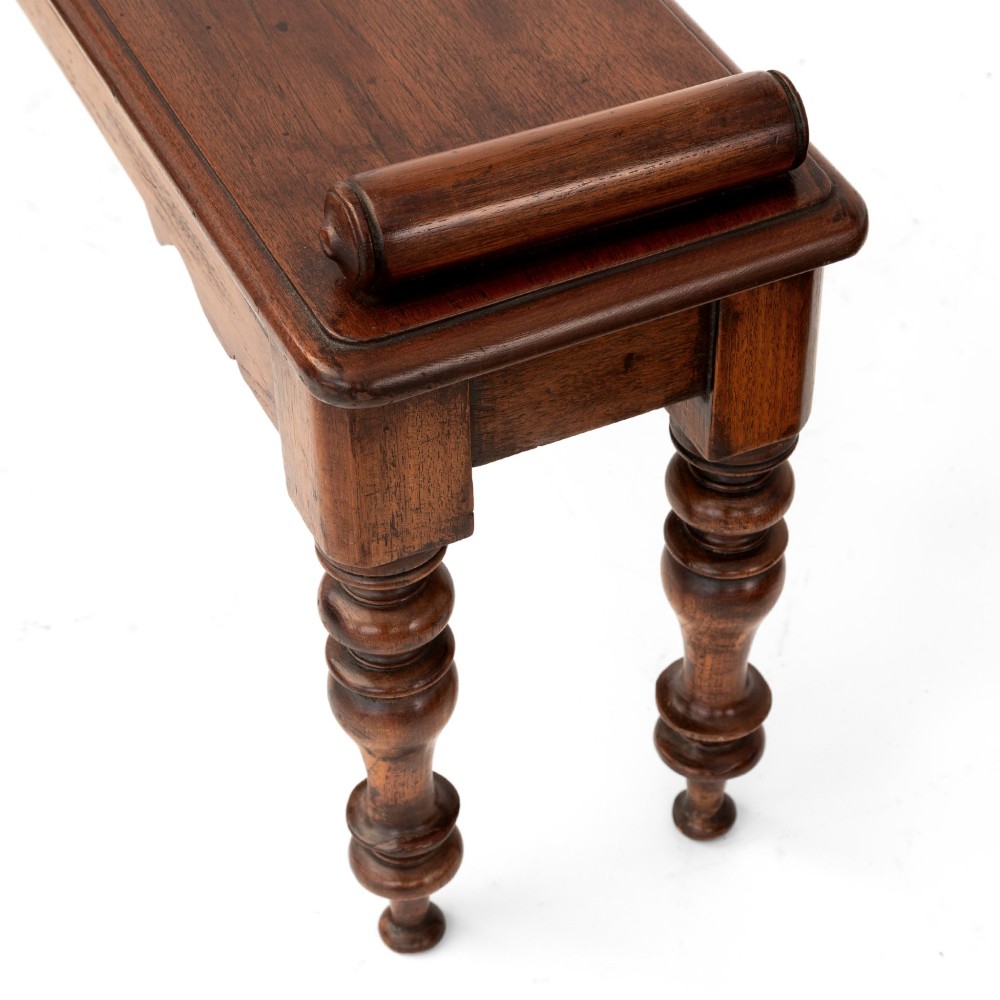 A long polished mahogany hall bench featuring turned legs, cylindrical bolster ends, and a central carved rosette on the apron. View III