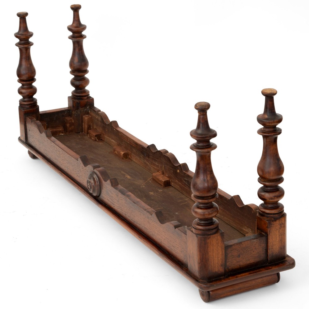 A long polished mahogany hall bench featuring turned legs, cylindrical bolster ends, and a central carved rosette on the apron. View VI