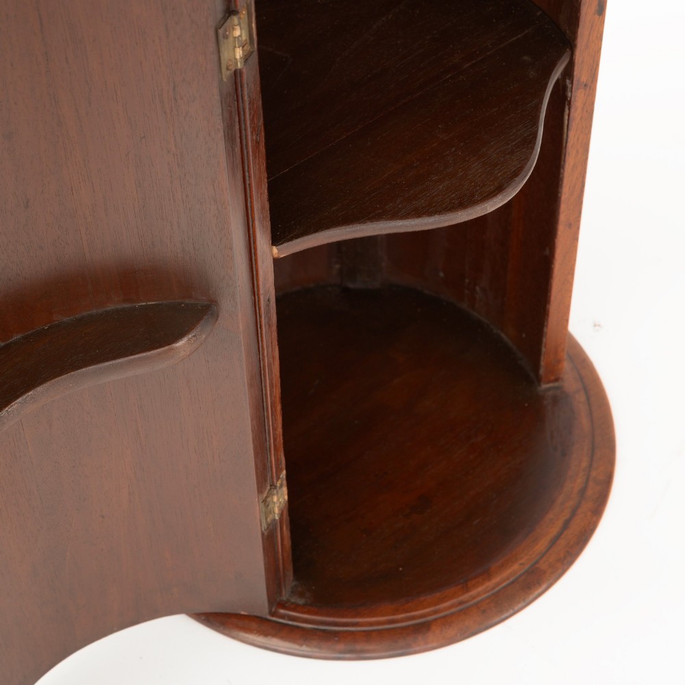 A Victorian cylindrical figured mahogany pot cupboard featuring a single curved door and an inset marble top. View III