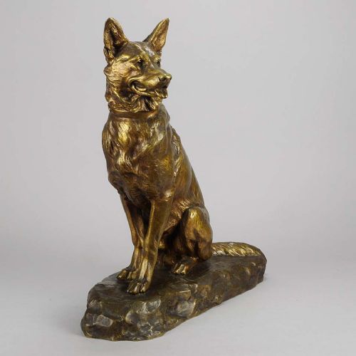 fig 1. A golden-brown patinated bronze sculpture depicting an alert seated Alsatian dog set upon an integral naturalistic base.