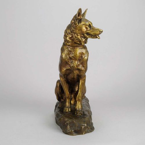fig 2. A golden-brown patinated bronze sculpture depicting an alert seated Alsatian dog set upon an integral naturalistic base.
