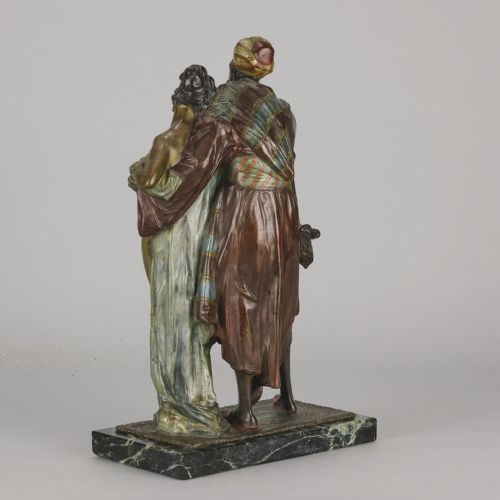 fig 3. An early 20th-century cold-painted bronze Orientalist figure group mounted on a rectangular dark green veined marble base.
