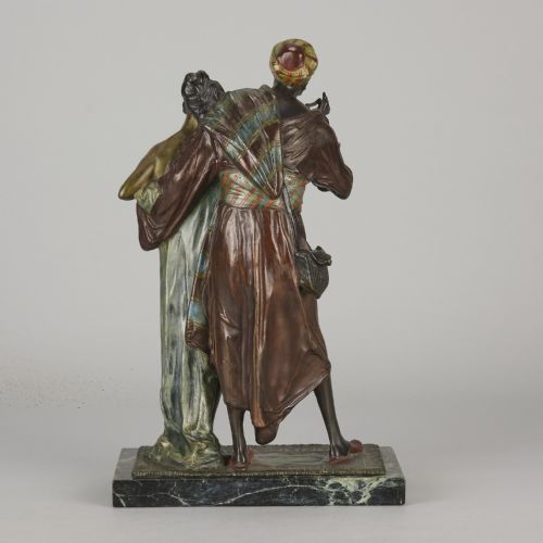 fig 4. An early 20th-century cold-painted bronze Orientalist figure group mounted on a rectangular dark green veined marble base.