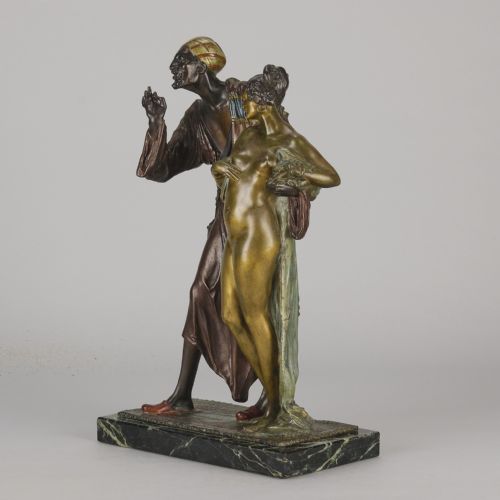 fig 5. An early 20th-century cold-painted bronze Orientalist figure group mounted on a rectangular dark green veined marble base.