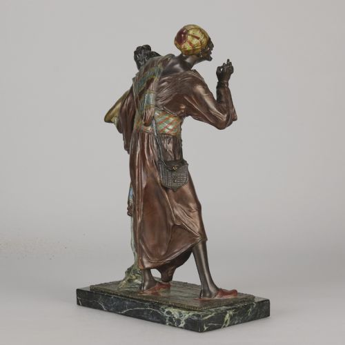 fig 6. An early 20th-century cold-painted bronze Orientalist figure group mounted on a rectangular dark green veined marble base.