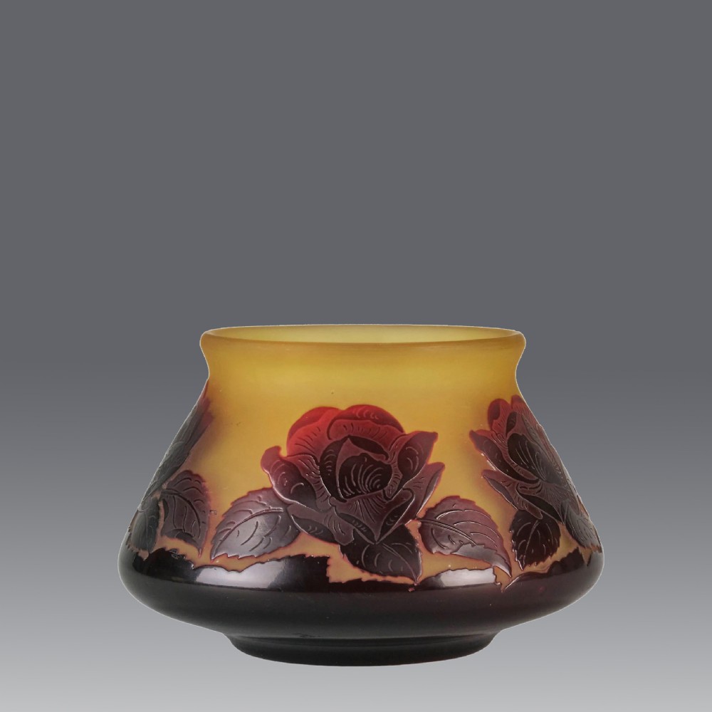 A squatted Art Nouveau cameo glass bowl featuring dark red rose motifs acid-etched over a frosted yellow and amber glass body. View II