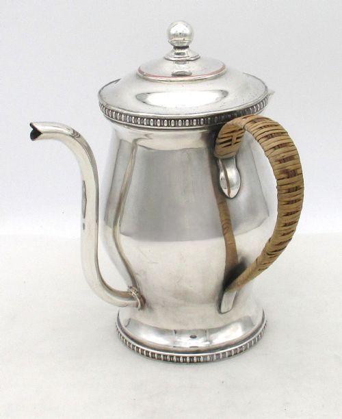 fig 1. An eighteenth-century silver-plated argyll gravy warmer with a baluster body, beaded borders, goose-neck spout, and cane-wrapped handle.