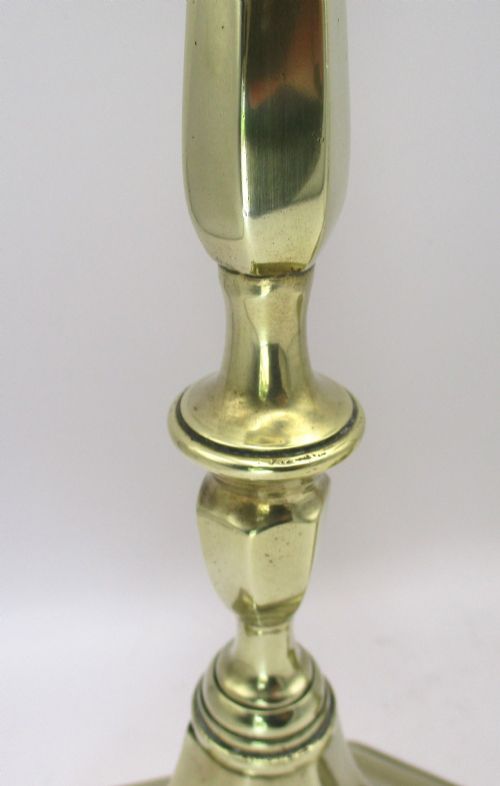 A pair of tall antique brass church candlesticks featuring faceted stems, hexagonal drip pans, and stepped hexagonal bases. View III