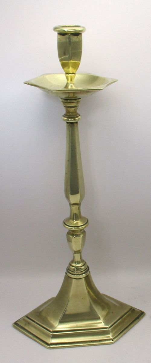 A pair of tall antique brass church candlesticks featuring faceted stems, hexagonal drip pans, and stepped hexagonal bases. View IV
