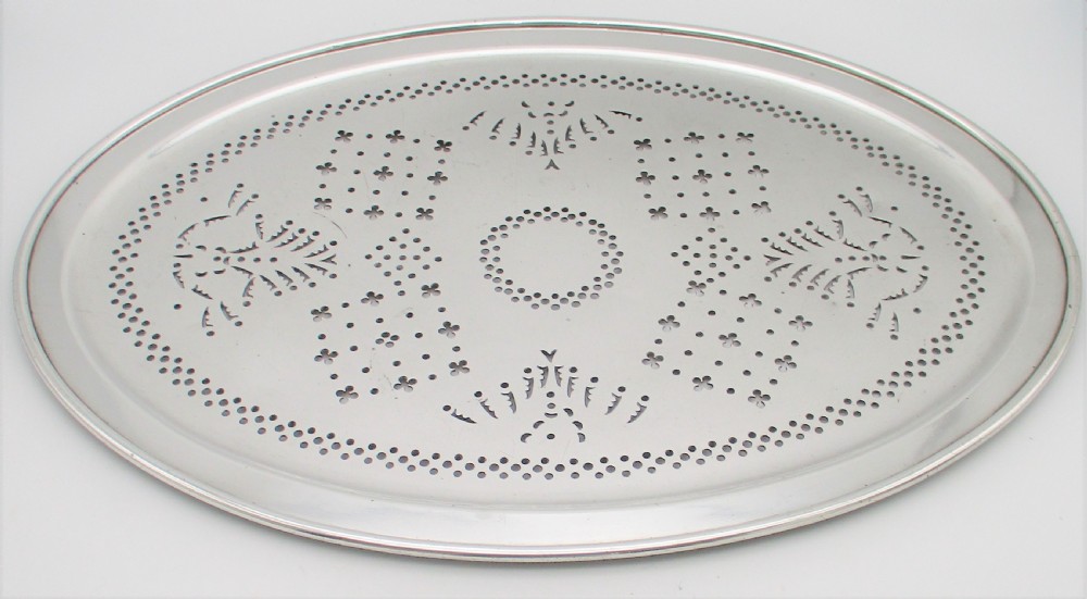 An oval 19th-century silver-plated mazarine draining tray featuring intricate pierced geometric patterns and foliate scrollwork. View II