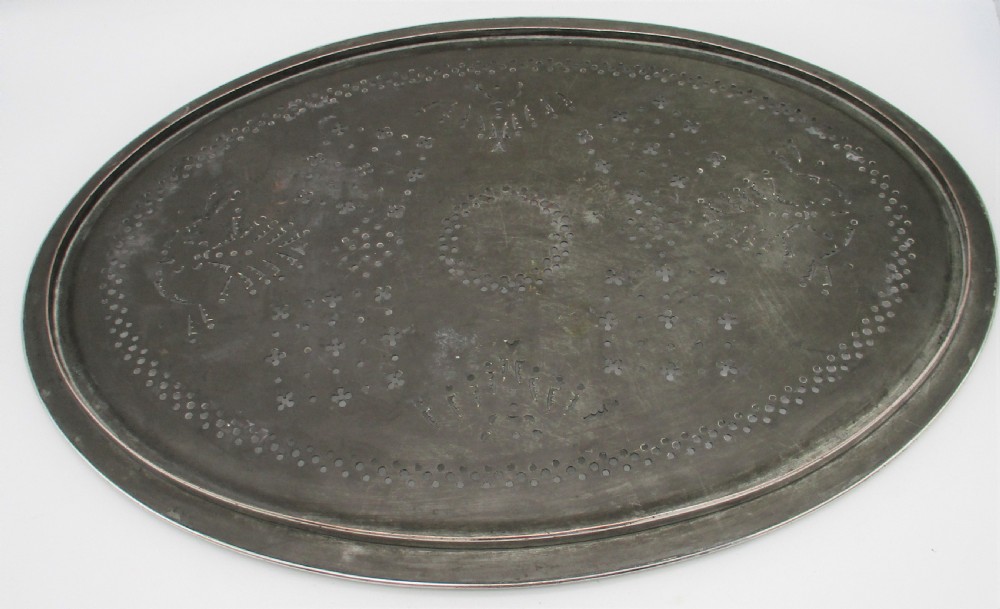An oval 19th-century silver-plated mazarine draining tray featuring intricate pierced geometric patterns and foliate scrollwork. View VIII