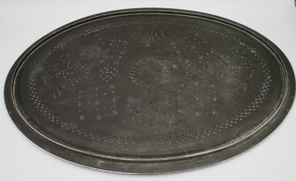 An oval 19th-century silver-plated mazarine draining tray featuring intricate pierced geometric patterns and foliate scrollwork. View IX
