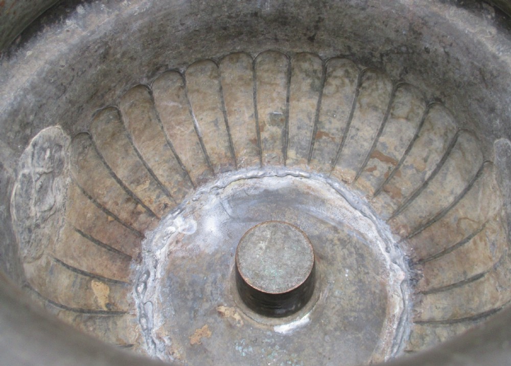 An antique silver-plated urn-shaped wine cooler featuring gadrooned lower details, twin scroll handles, engraved leaf motifs, and subtle copper exposure along worn edges. View V