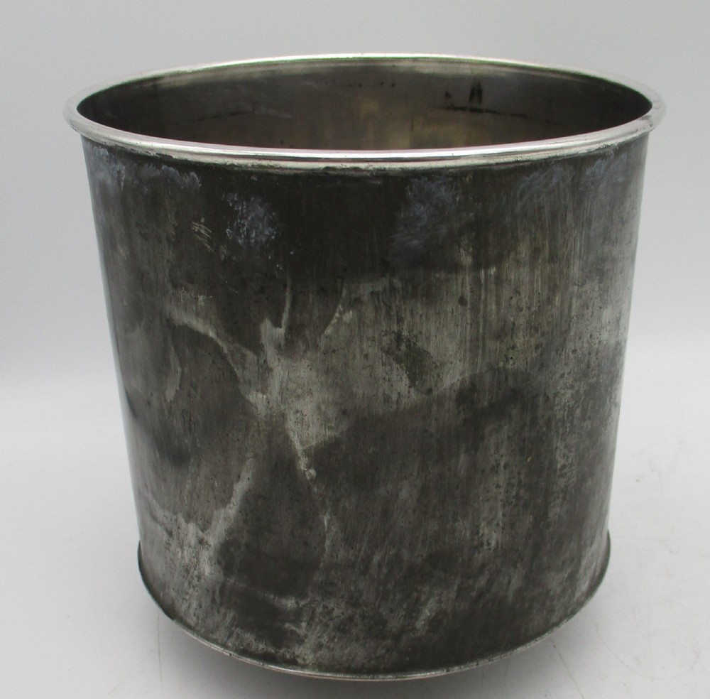 An antique silver-plated urn-shaped wine cooler featuring gadrooned lower details, twin scroll handles, engraved leaf motifs, and subtle copper exposure along worn edges. View VIII