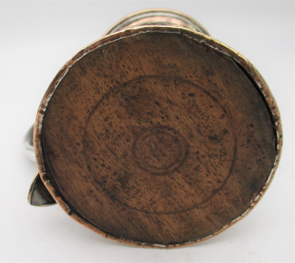 An 18th-century Old Sheffield silver-plated pint tankard with a curved handle and visible copper exposure along the rim and base. View VI