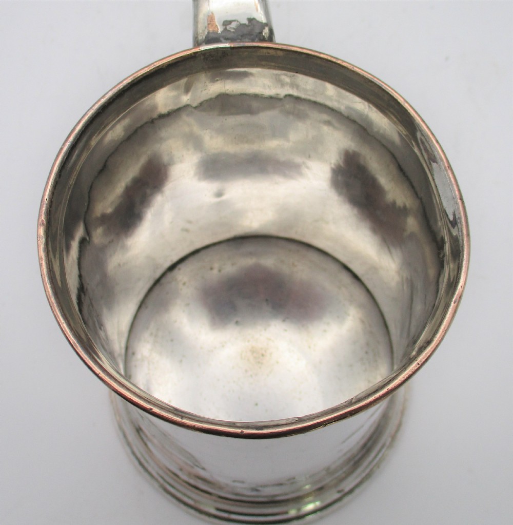 An 18th-century Old Sheffield silver-plated pint tankard with a curved handle and visible copper exposure along the rim and base. View VII