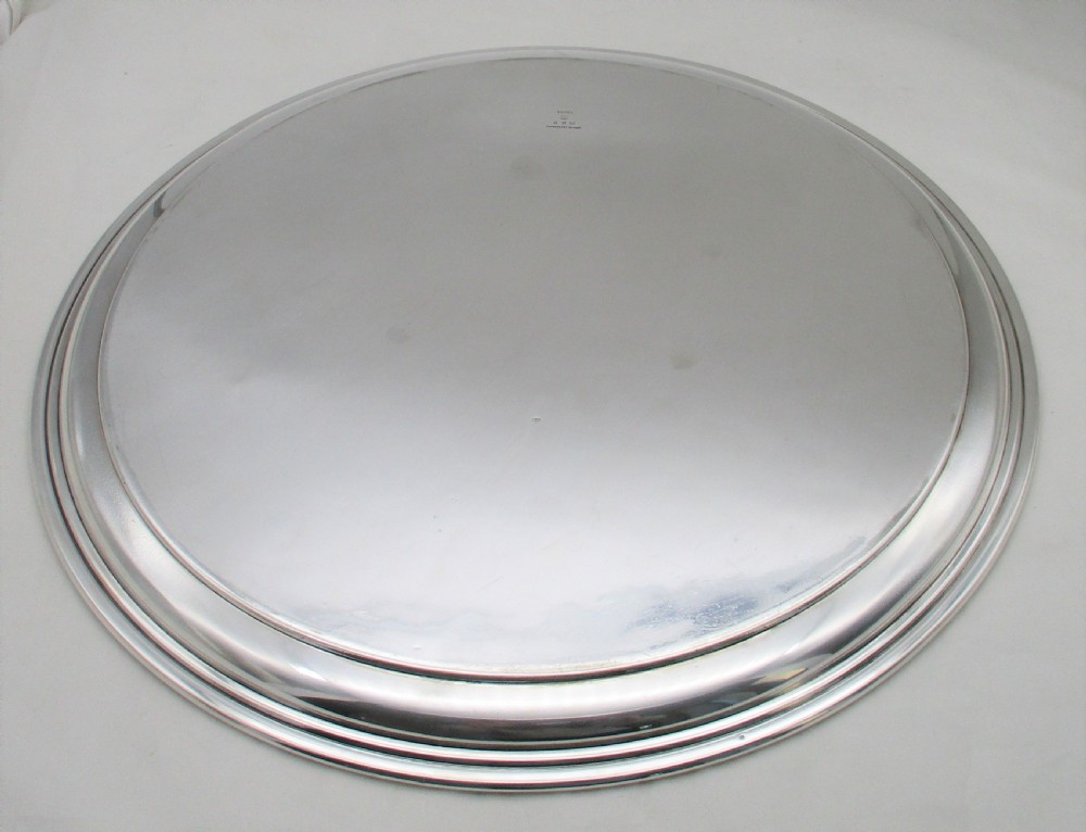 A round silver-plated cocktail tray with engine-turned concentric patterning and an unengraved central circular cartouche. View VI