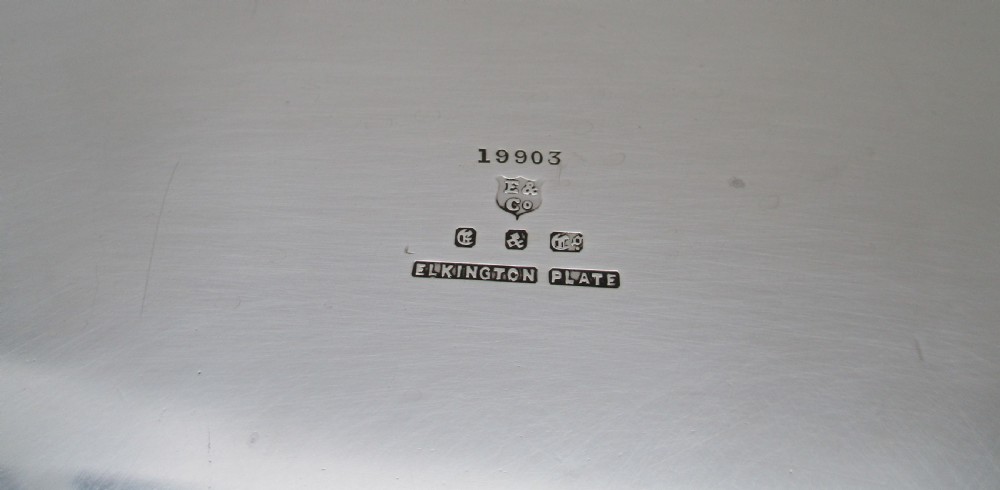 A round silver-plated cocktail tray with engine-turned concentric patterning and an unengraved central circular cartouche. View VII