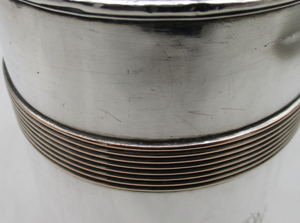 A Georgian Old Sheffield silver-plated quart tankard featuring a tapered body with reeded copper bands and a curved handle. View IV