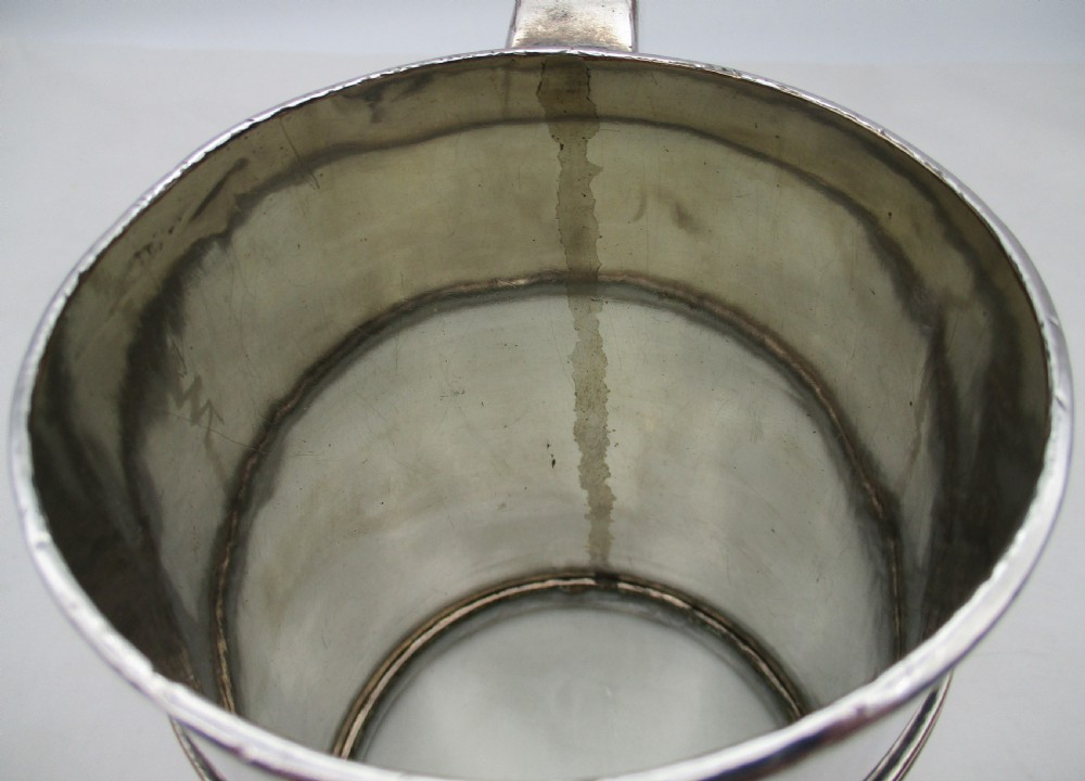A Georgian Old Sheffield silver-plated quart tankard featuring a tapered body with reeded copper bands and a curved handle. View V