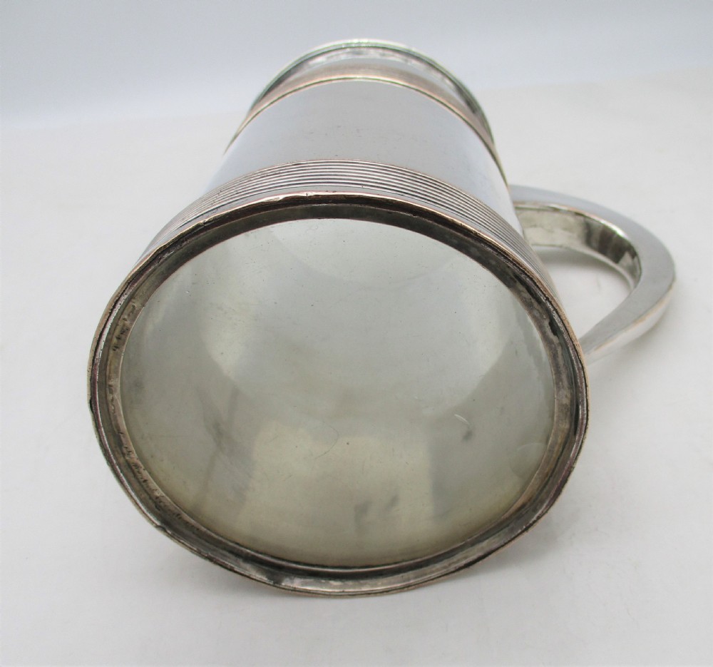 A Georgian Old Sheffield silver-plated quart tankard featuring a tapered body with reeded copper bands and a curved handle. View VII