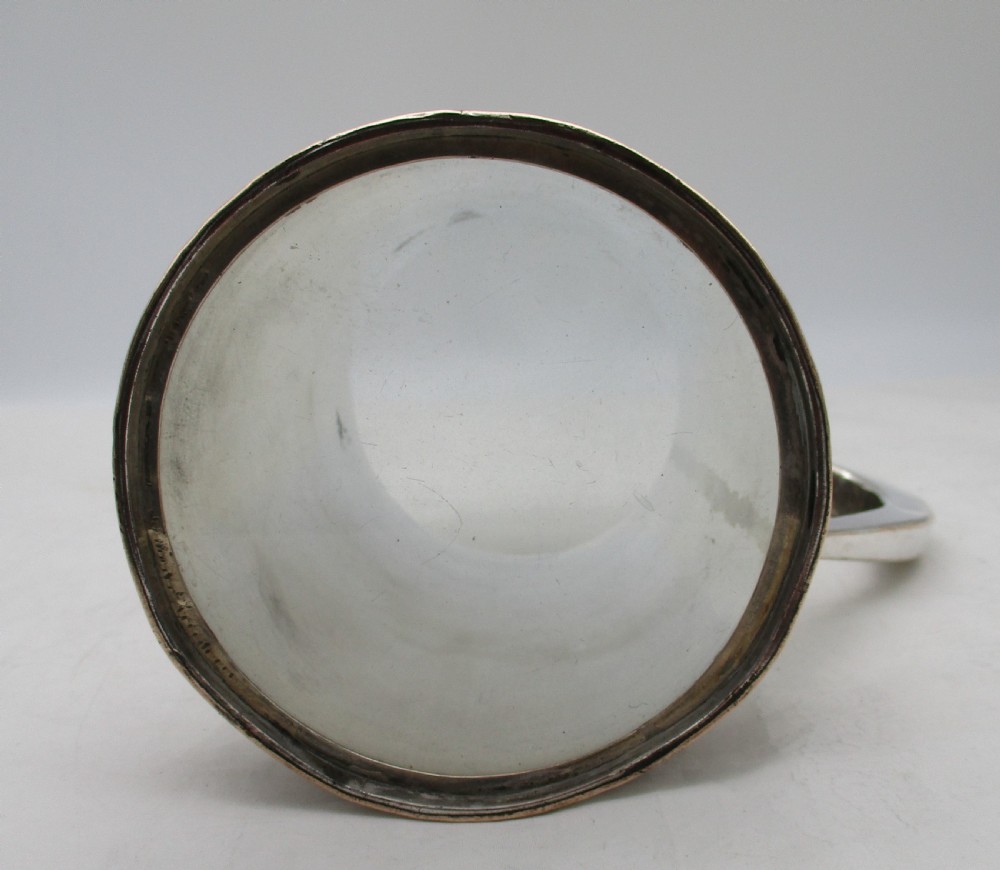 A Georgian Old Sheffield silver-plated quart tankard featuring a tapered body with reeded copper bands and a curved handle. View VIII