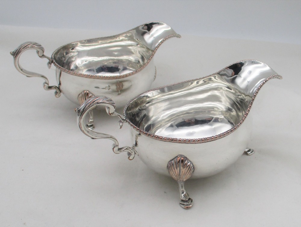 A pair of silver-plated sauce boats featuring double-scroll handles, gadrooned rims, and shell-capped feet. View III