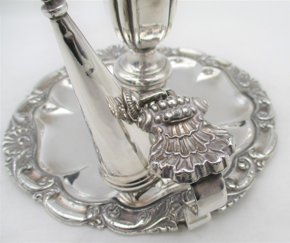 A 19th-century silver-plated chamber stick featuring a scalloped rim, central sconce, engraved crest on the dish, and a fitted conical snuffer. View III