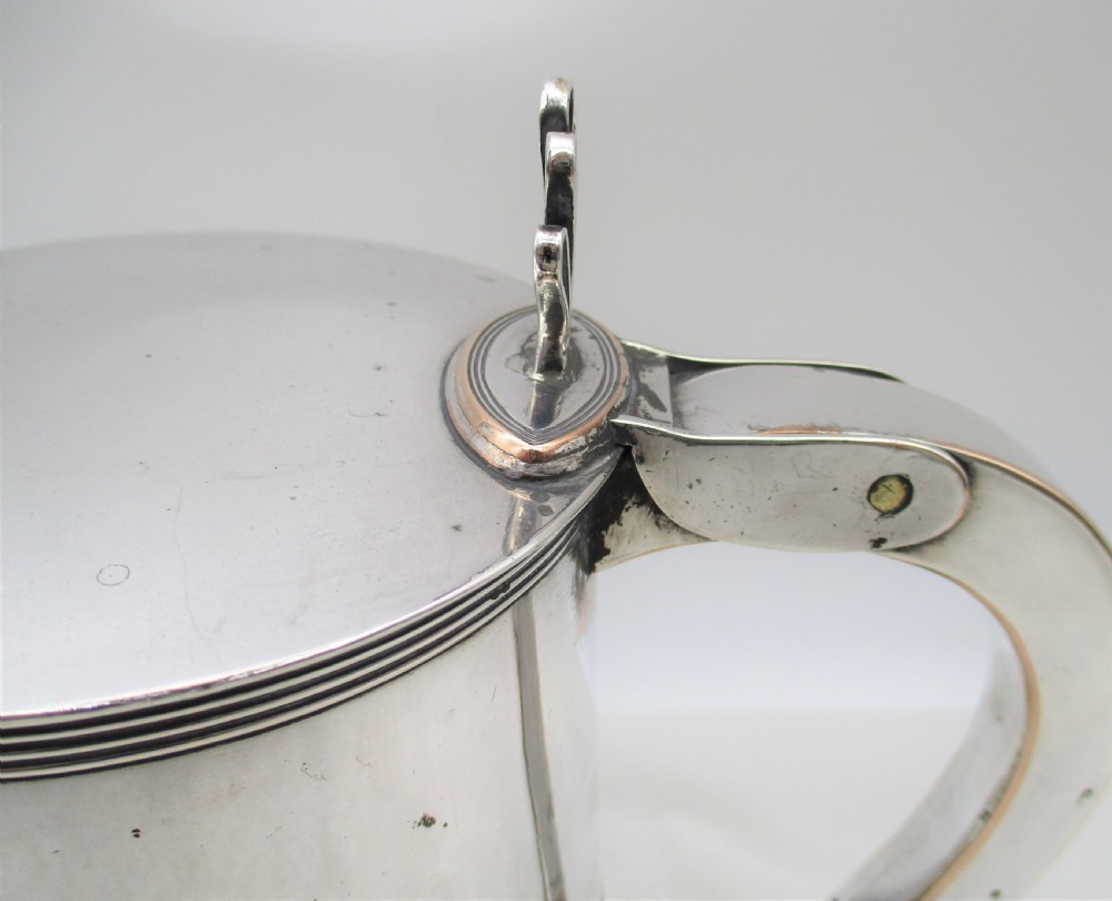 A 19th-century silver-plated beer jug with a hinged lid, reeded horizontal bands, and a sturdy curved handle. View III