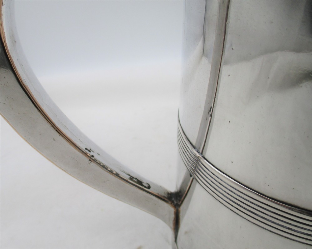 A 19th-century silver-plated beer jug with a hinged lid, reeded horizontal bands, and a sturdy curved handle. View VIII