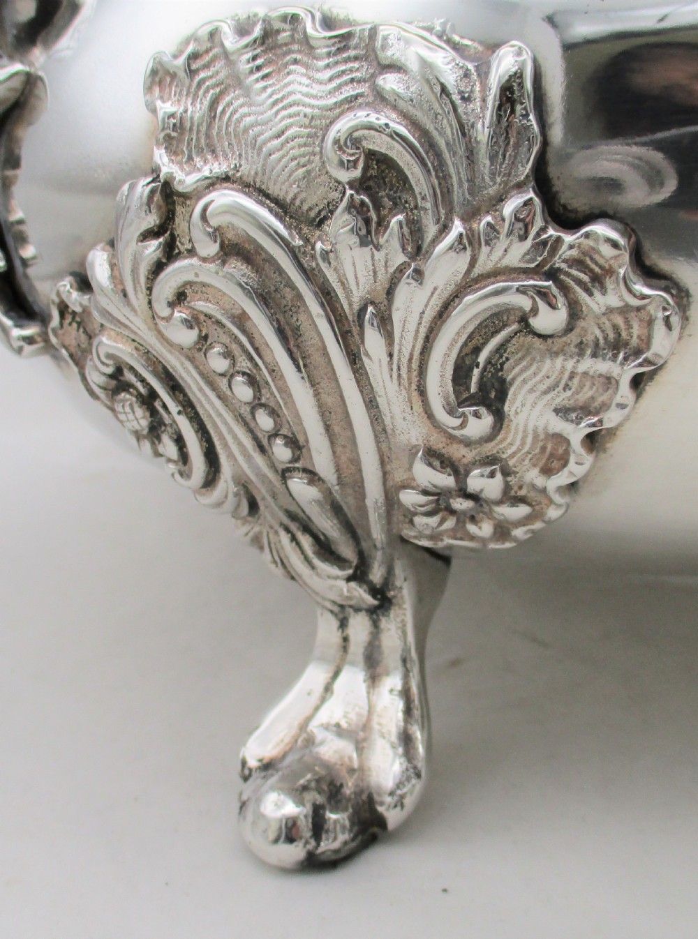 A large 19th-century silver-plated soup tureen featuring leaf-form handles, a domed lid with a scroll finial, and four scroll feet. View IV