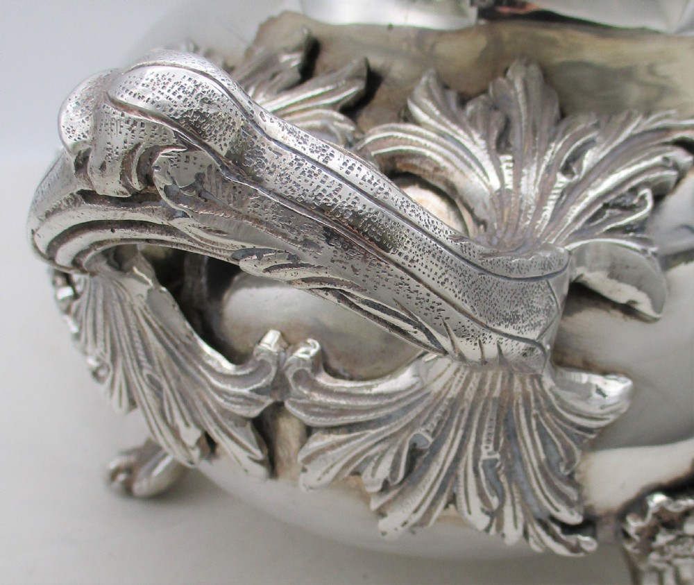 A large 19th-century silver-plated soup tureen featuring leaf-form handles, a domed lid with a scroll finial, and four scroll feet. View VIII