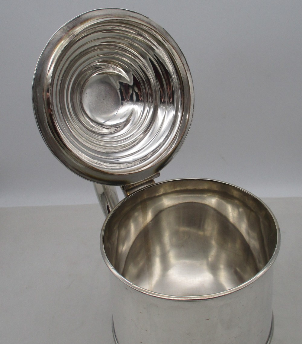 A Georgian Old Sheffield plated silver tankard featuring a domed gadrooned lid, sturdy scroll handle, and subtle copper show-through along the base. View VIII