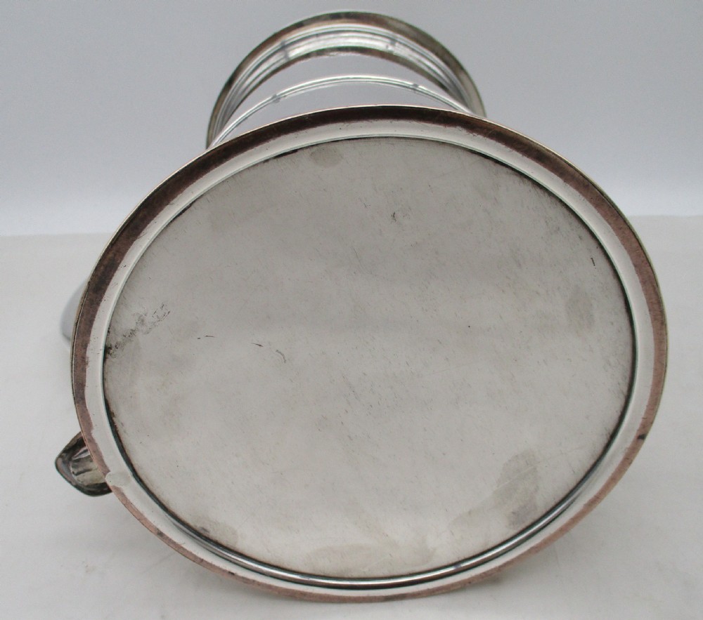 A Georgian Old Sheffield plated silver tankard featuring a domed gadrooned lid, sturdy scroll handle, and subtle copper show-through along the base. View X