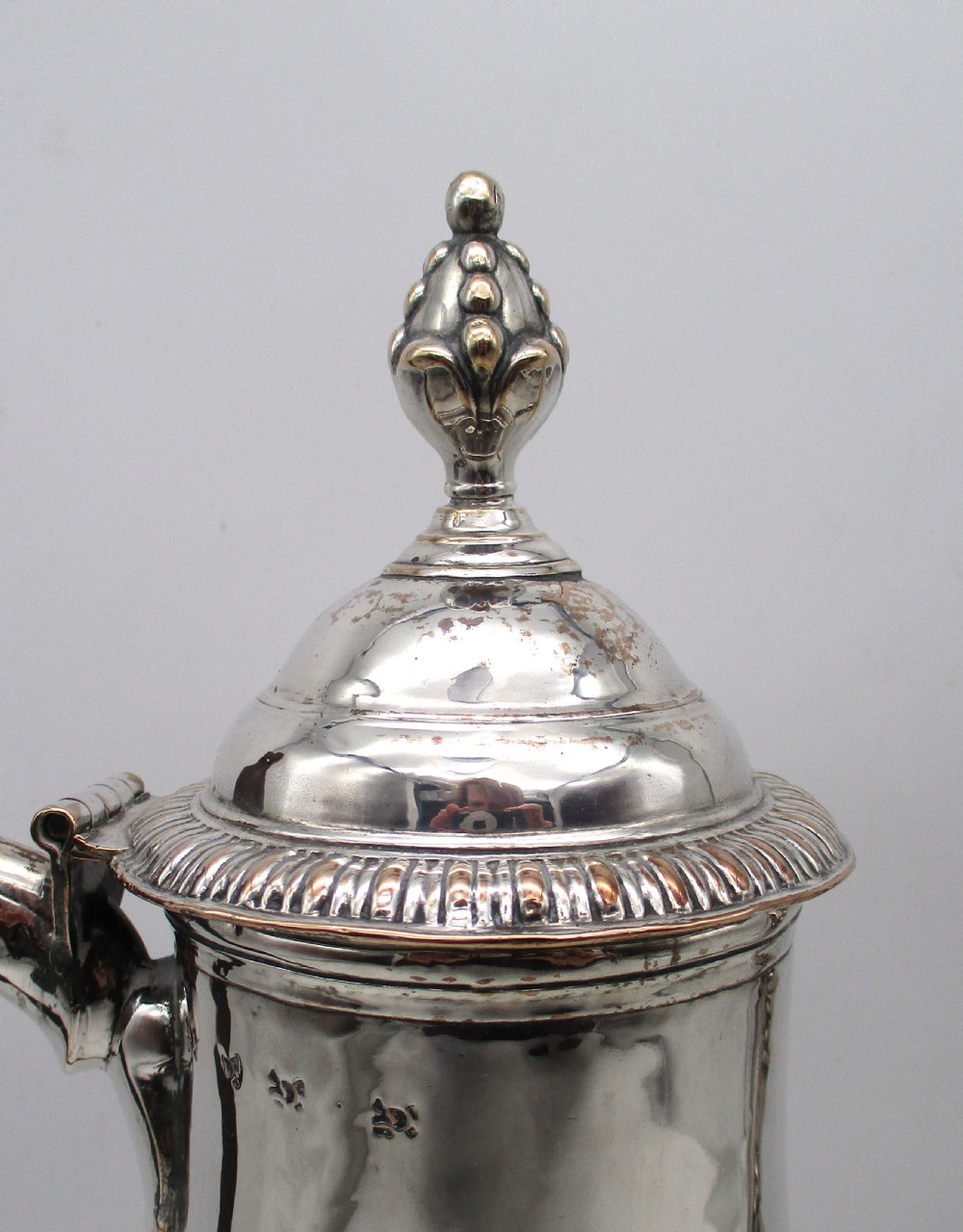 An 18th-century baluster-shaped Sheffield plate coffee pot featuring a wooden carved handle, decorative spout, and gadrooned base. View II