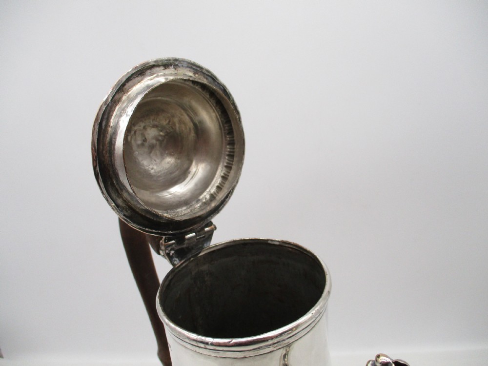 An 18th-century baluster-shaped Sheffield plate coffee pot featuring a wooden carved handle, decorative spout, and gadrooned base. View VII