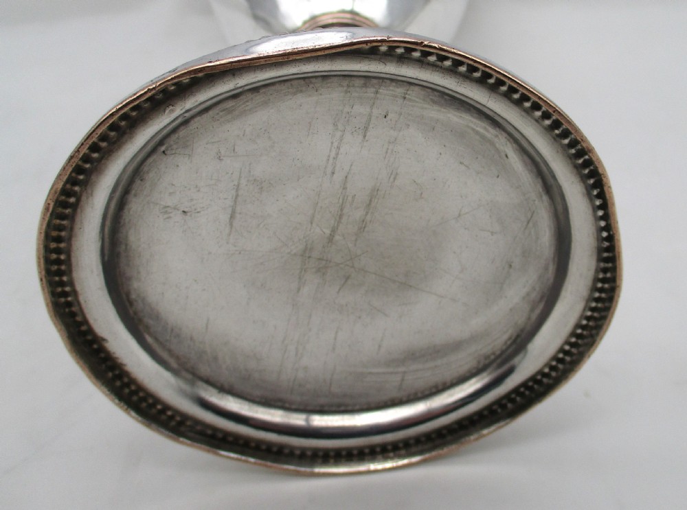 An 18th-century Sheffield plated silver chalice featuring a tapered bowl, a turned stem, a beaded foot rim, and a gilded interior. View V
