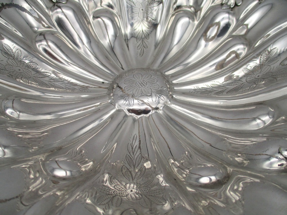 A 19th-century silver-plated bread basket featuring a fluted rim, floral engraving, pedestal base, and an arched swing handle. View IV