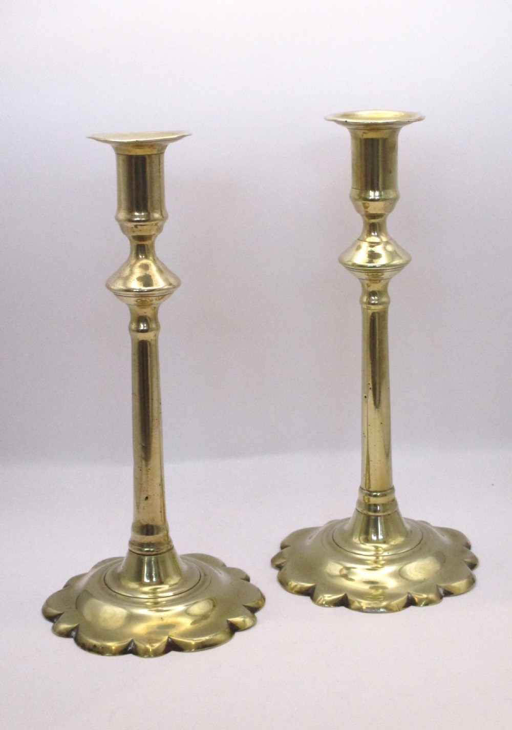 A Pair of Tall Georgian Brass Candlesticks