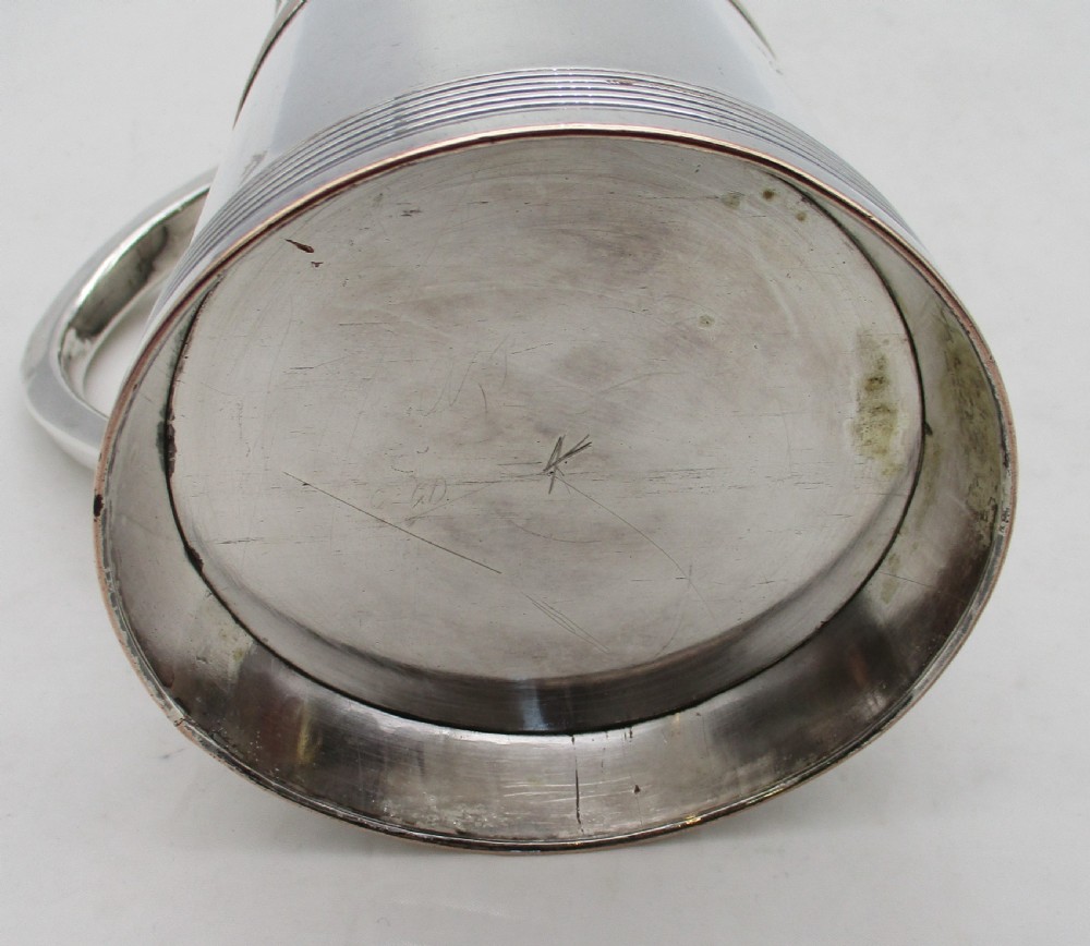A Georgian silver-plated cylindrical tankard featuring reeded horizontal banding and a curved handle. View VI