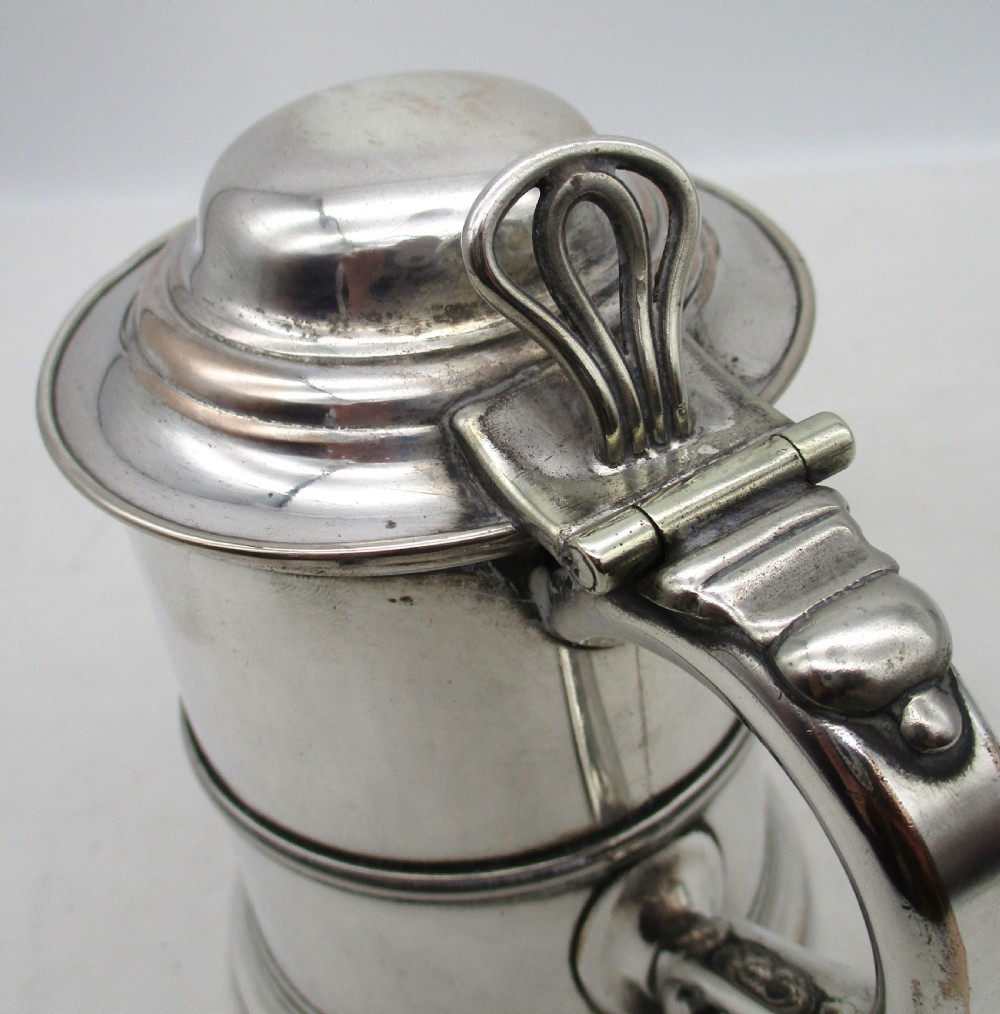 A Georgian silver-plated cylindrical tankard featuring reeded horizontal banding and a curved handle. View IX