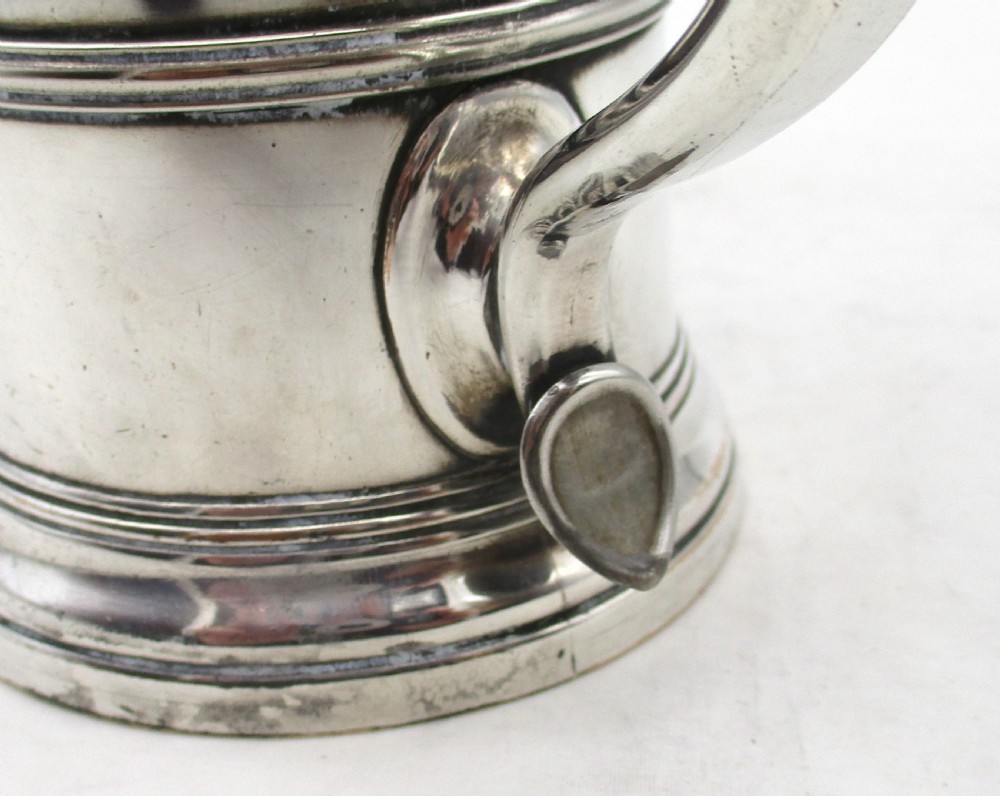 A Georgian silver-plated cylindrical tankard featuring reeded horizontal banding and a curved handle. View X