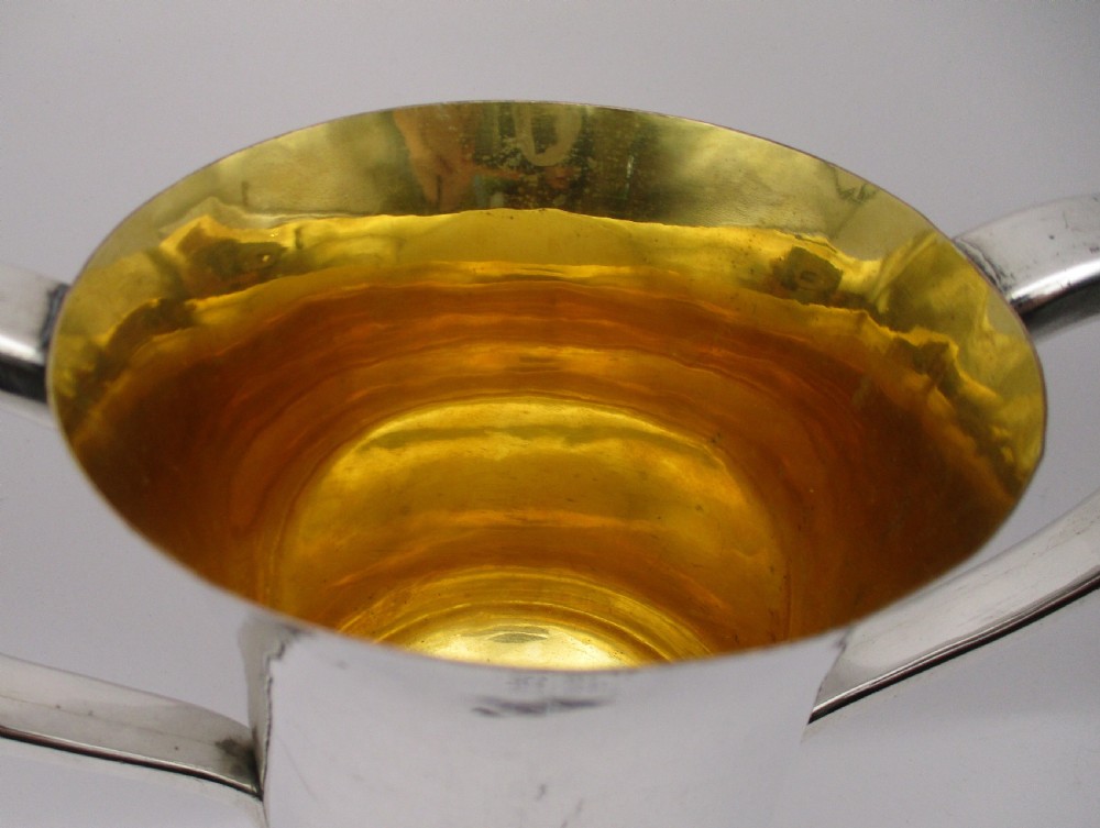 A 19th-century silver-plated two-handled loving cup with a gilt interior and central monogram engraving on a stepped circular pedestal base. View III