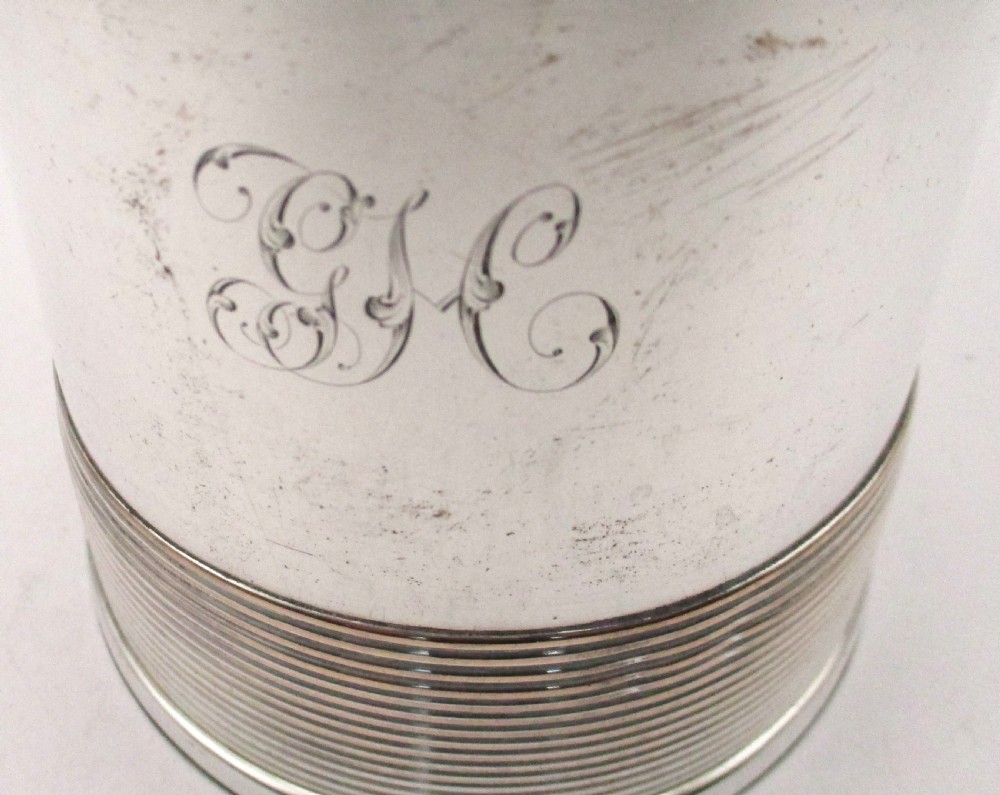 A cylindrical Georgian Sheffield plated silver tankard featuring horizontal reeded bands, an engraved monogram, and a polished loop handle. View III