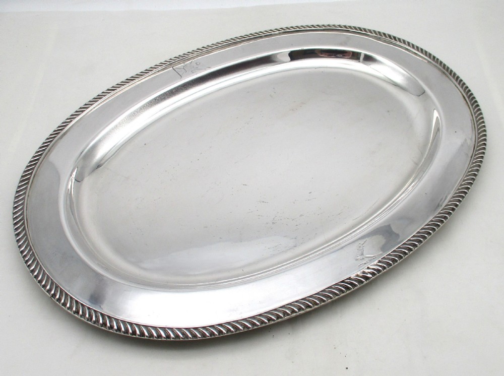 A pair of oval mid-nineteenth-century silver-plated meat platters featuring gadrooned rims and engraved crests. View II