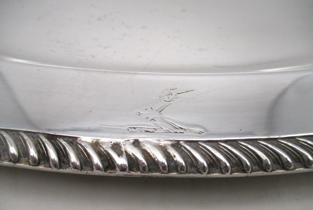 A pair of oval mid-nineteenth-century silver-plated meat platters featuring gadrooned rims and engraved crests. View III