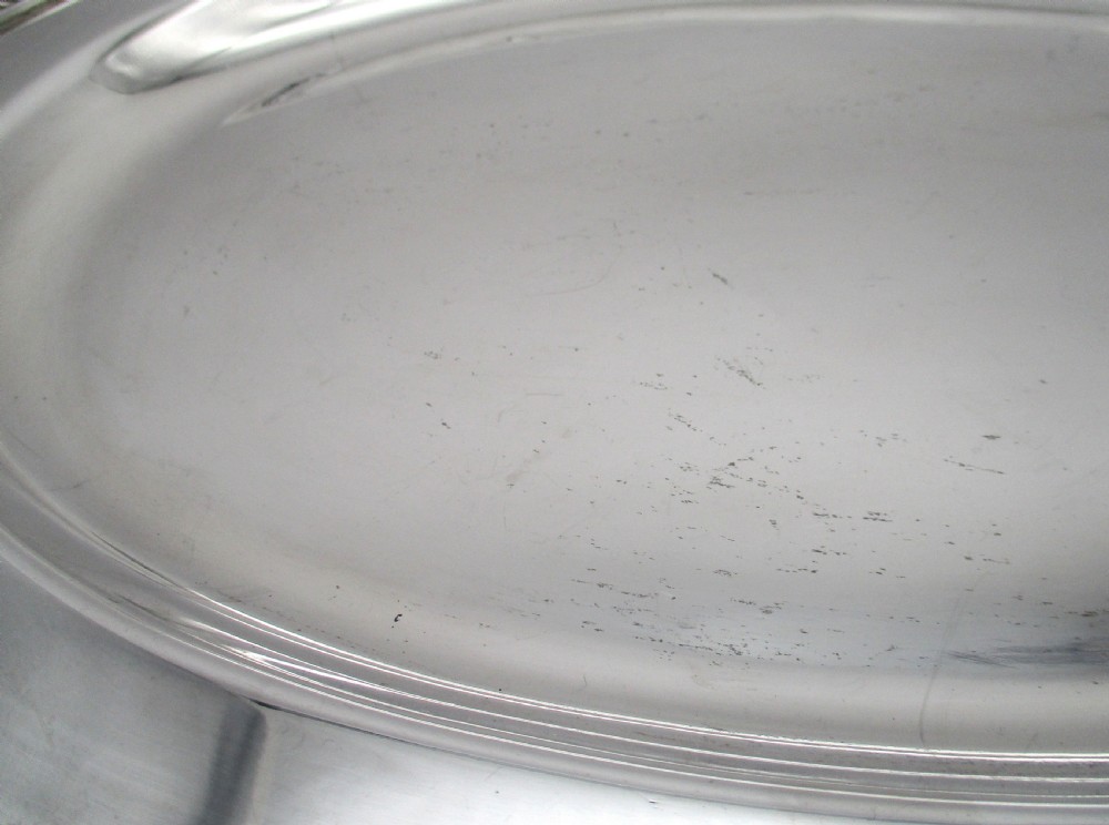 A pair of oval mid-nineteenth-century silver-plated meat platters featuring gadrooned rims and engraved crests. View IV