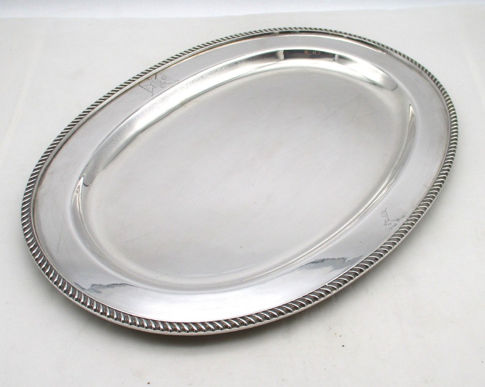A pair of oval mid-nineteenth-century silver-plated meat platters featuring gadrooned rims and engraved crests. View VIII
