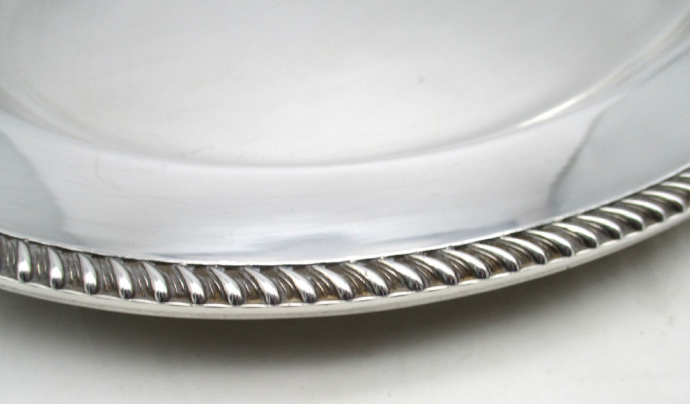 A pair of oval mid-nineteenth-century silver-plated meat platters featuring gadrooned rims and engraved crests. View IX