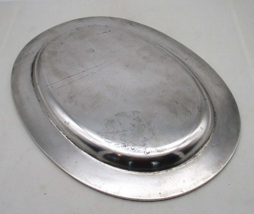 A pair of oval mid-nineteenth-century silver-plated meat platters featuring gadrooned rims and engraved crests. View X